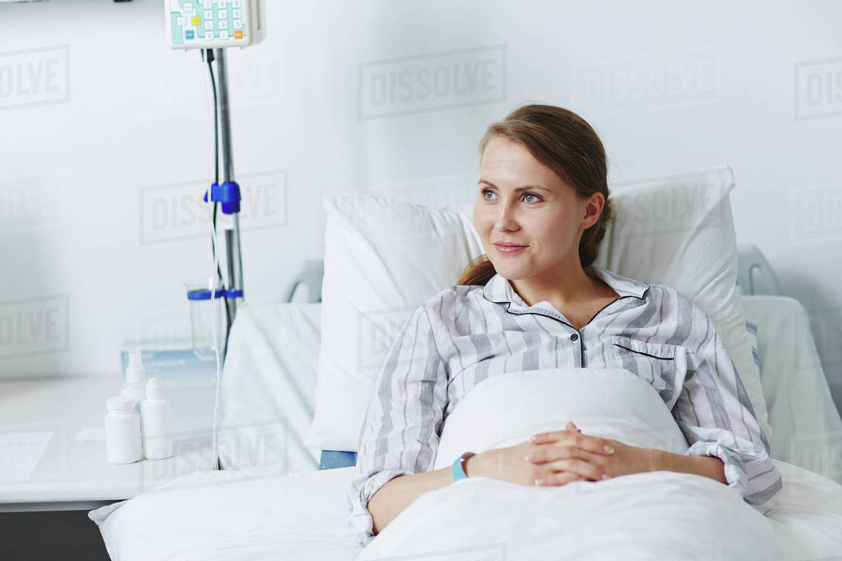 Content patient sitting in bed Stock Photo Dissolve