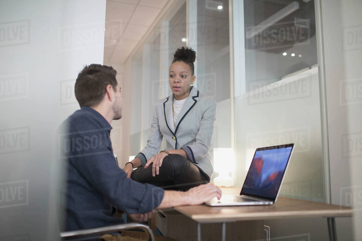 Young man and woman working in an an office. - Royalty-free Stock Photo ...
