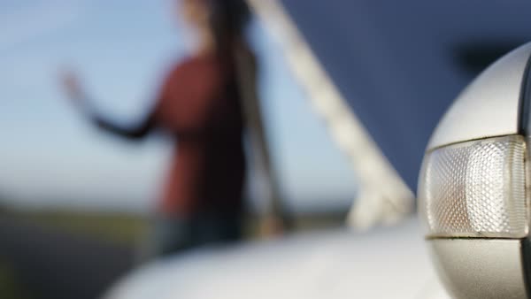 Blurred Man With A Broken Down Car Foreground Focus On Hazard Blurred Background Of Man With A Broken Down Car Foreground Focus On Hazard Lights Royalty