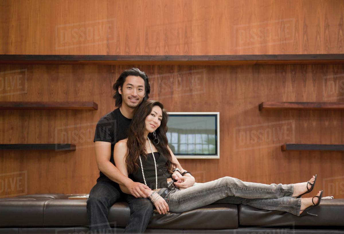 Korean couple on sofa Stock Photo Dissolve