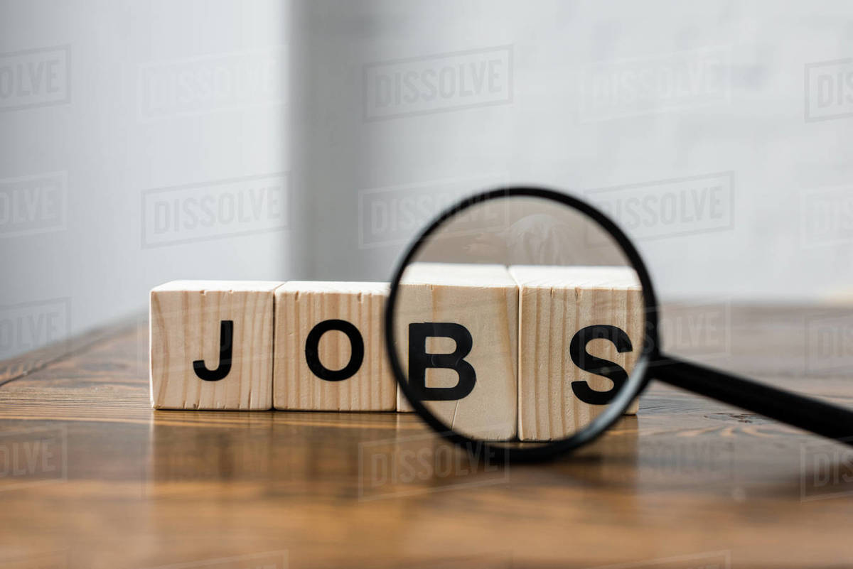 Close Up Shot Of Wooden Blocks With Jobs Sign And Magnifying Glass