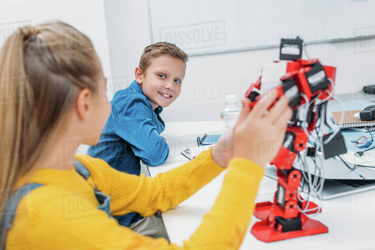 Schoolchildren programming robot together during stem educational class ...