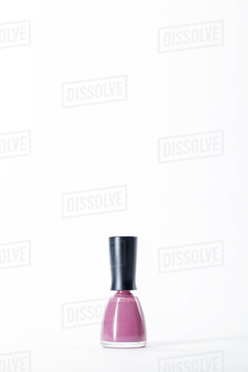 Bottle of shiny pink nail polish on white Stock Photo Dissolve