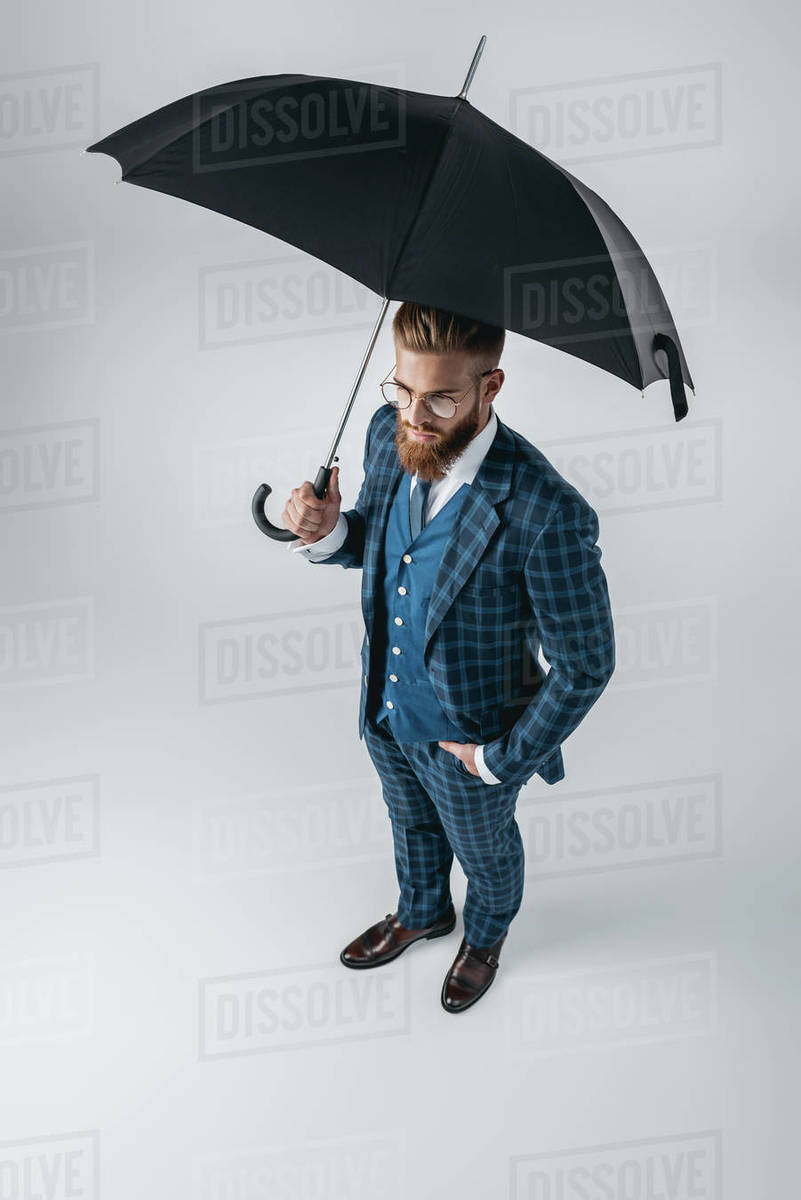 high angle view of handsome man in suit with opened umbrella isolated