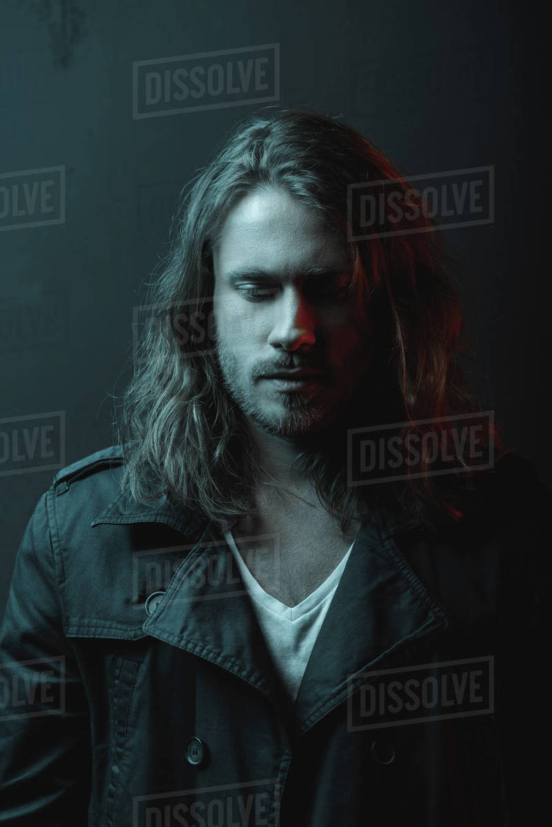 Portrait Of Handsome Stylish Bearded Young Man With Long Hair