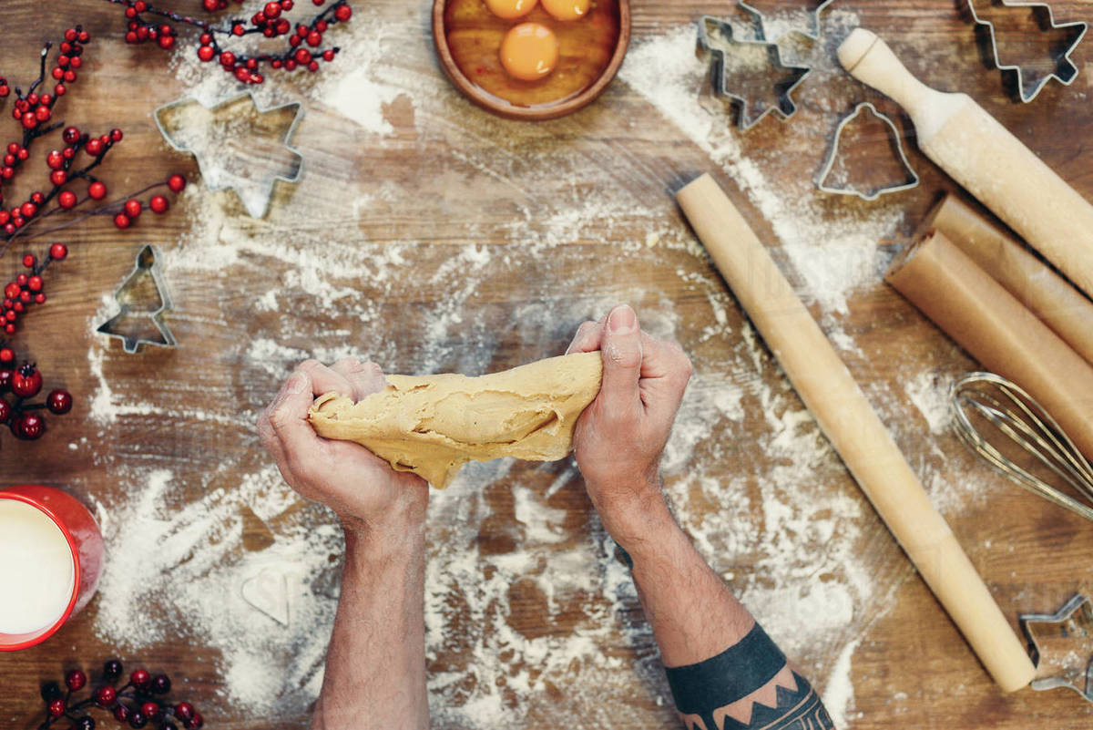 cropped shot of person kneading gingerbread dough for christmas cookies