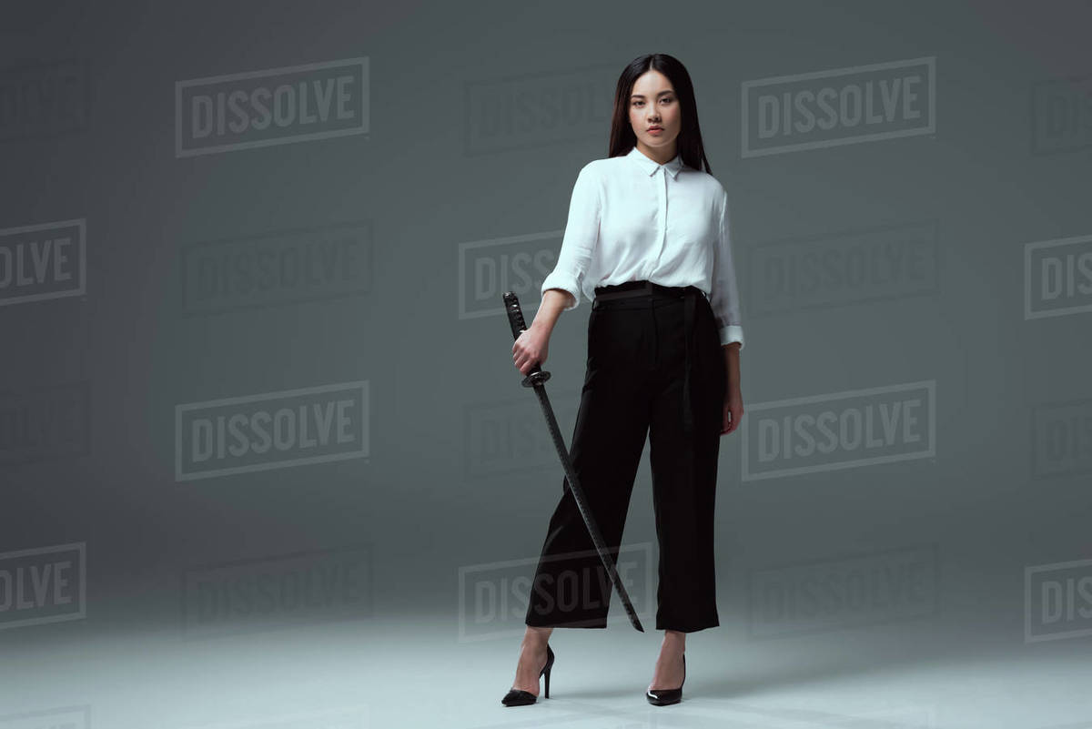 full-length-view-of-beautiful-young-asian-woman-holding-katana-and