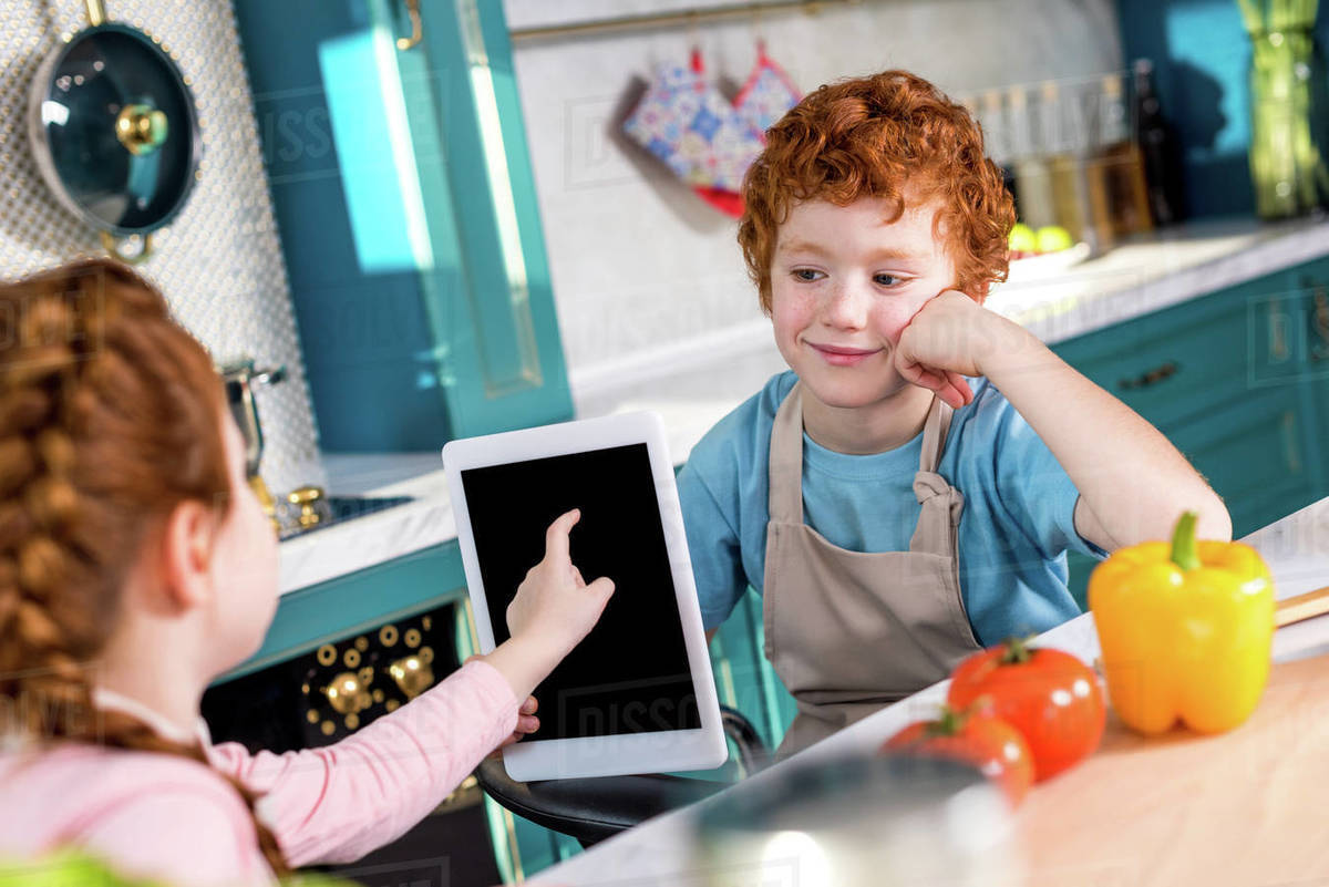 Cute Little Kids Using Digital Tablet While Cooking Together In
