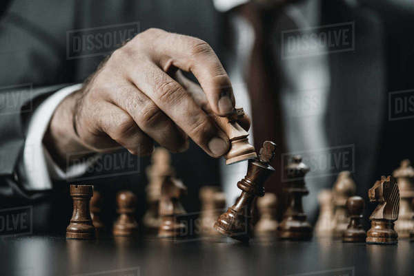 close up view of businessman holding chess figure in hand - Royalty ...