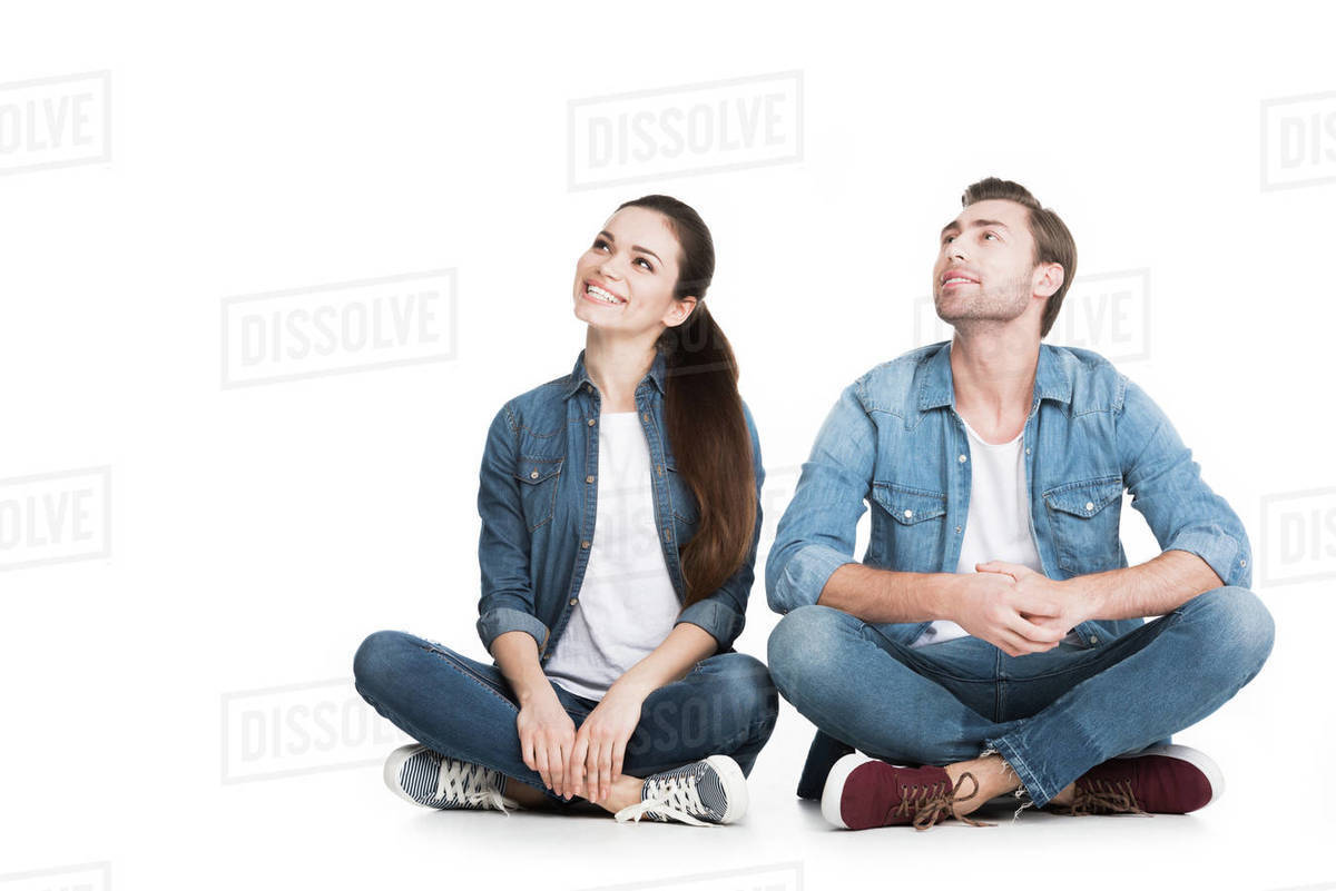 Couple sitting in denim clothes, isolated on white Stock Photo Dissolve