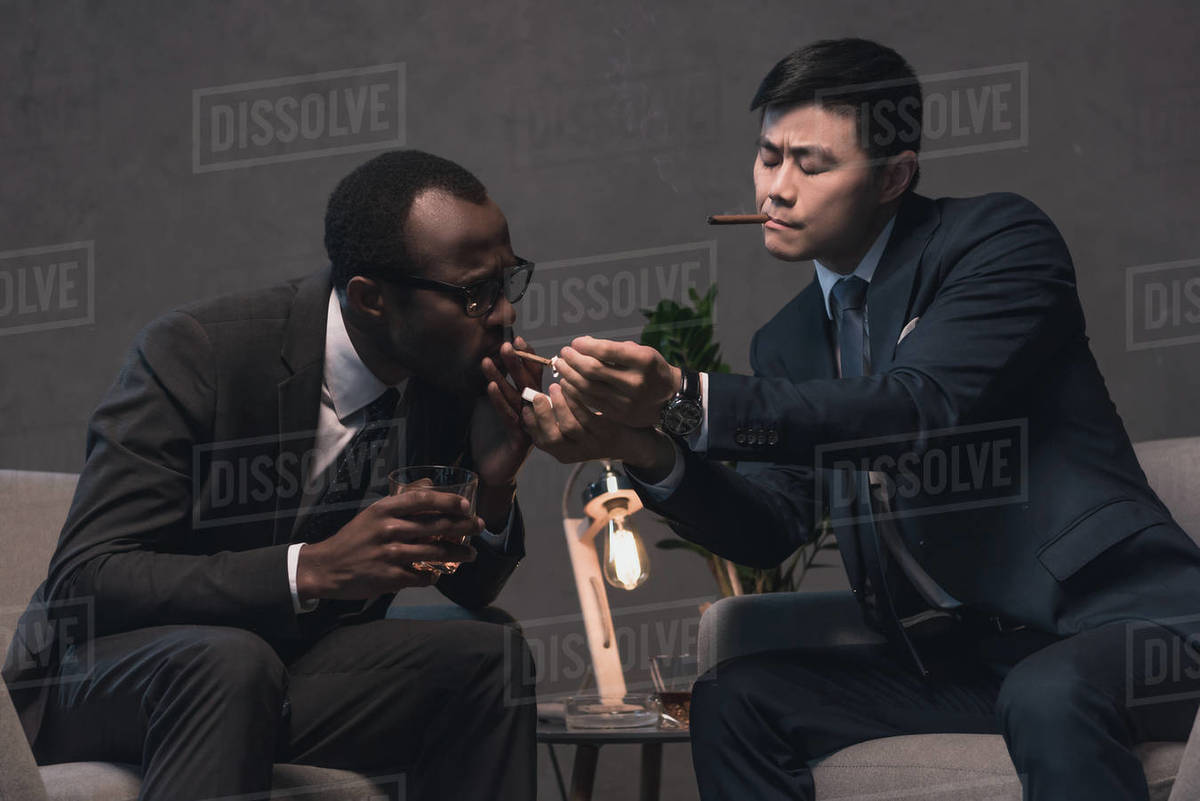 Successful multiethnic businessmen smoking cigars Stock Photo Dissolve