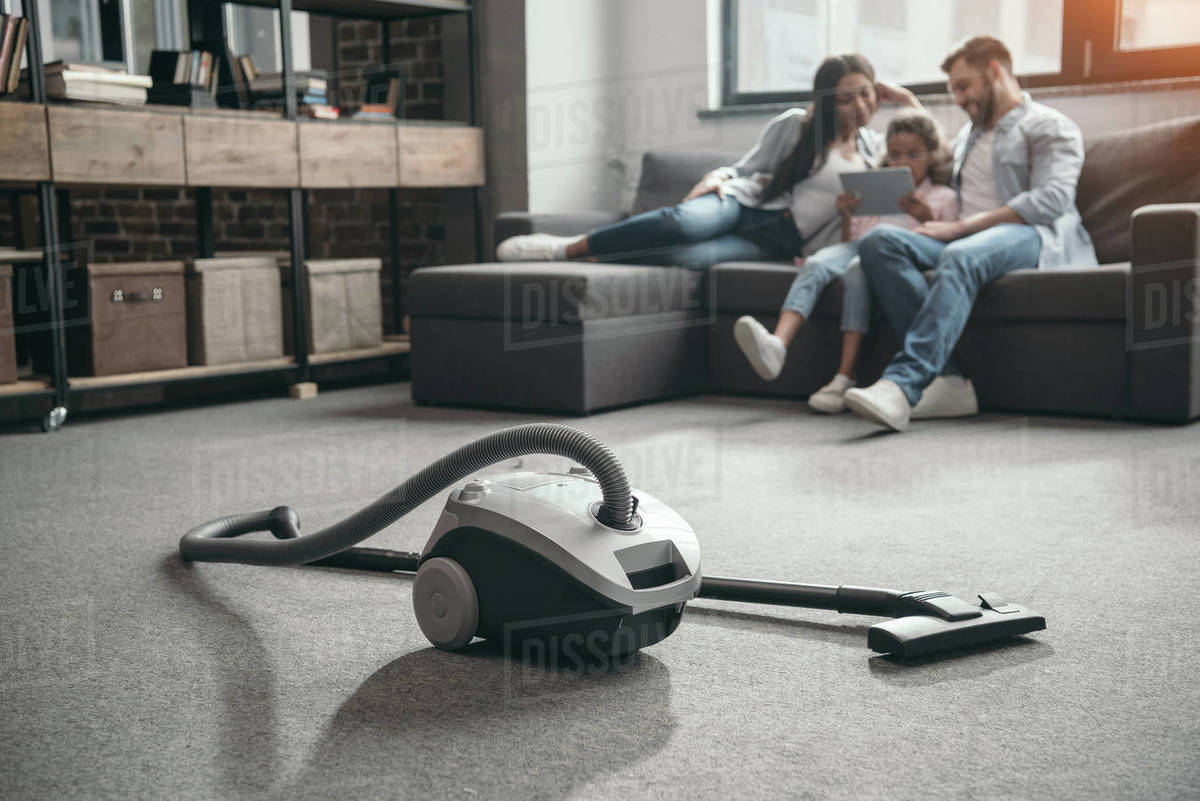 Family Sitting On Sofa And Using Digital Tablet Selective Focus