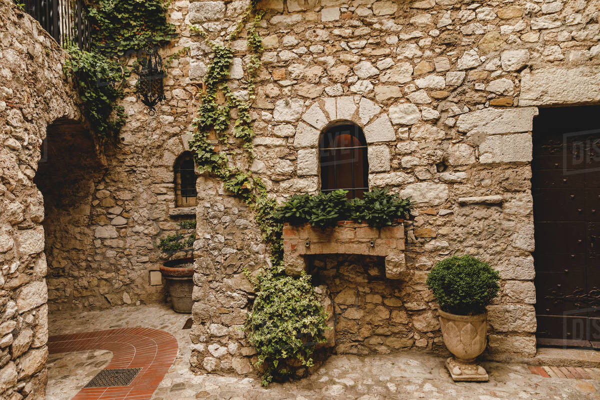 Plants at small atrium of ancient stone building, Eze, France - Stock ...