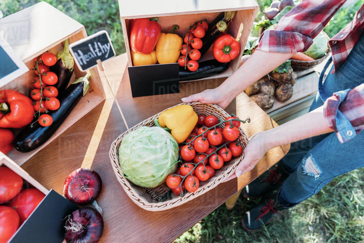 cropped shot of farmer selling healthy organic locally grown vegetables on stall Stock Photo