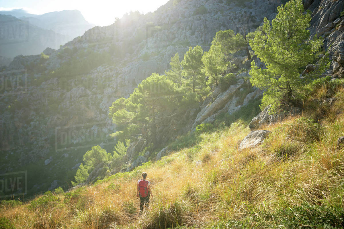 A young woman hiking in the backcountry of the Spanish island Mallorca