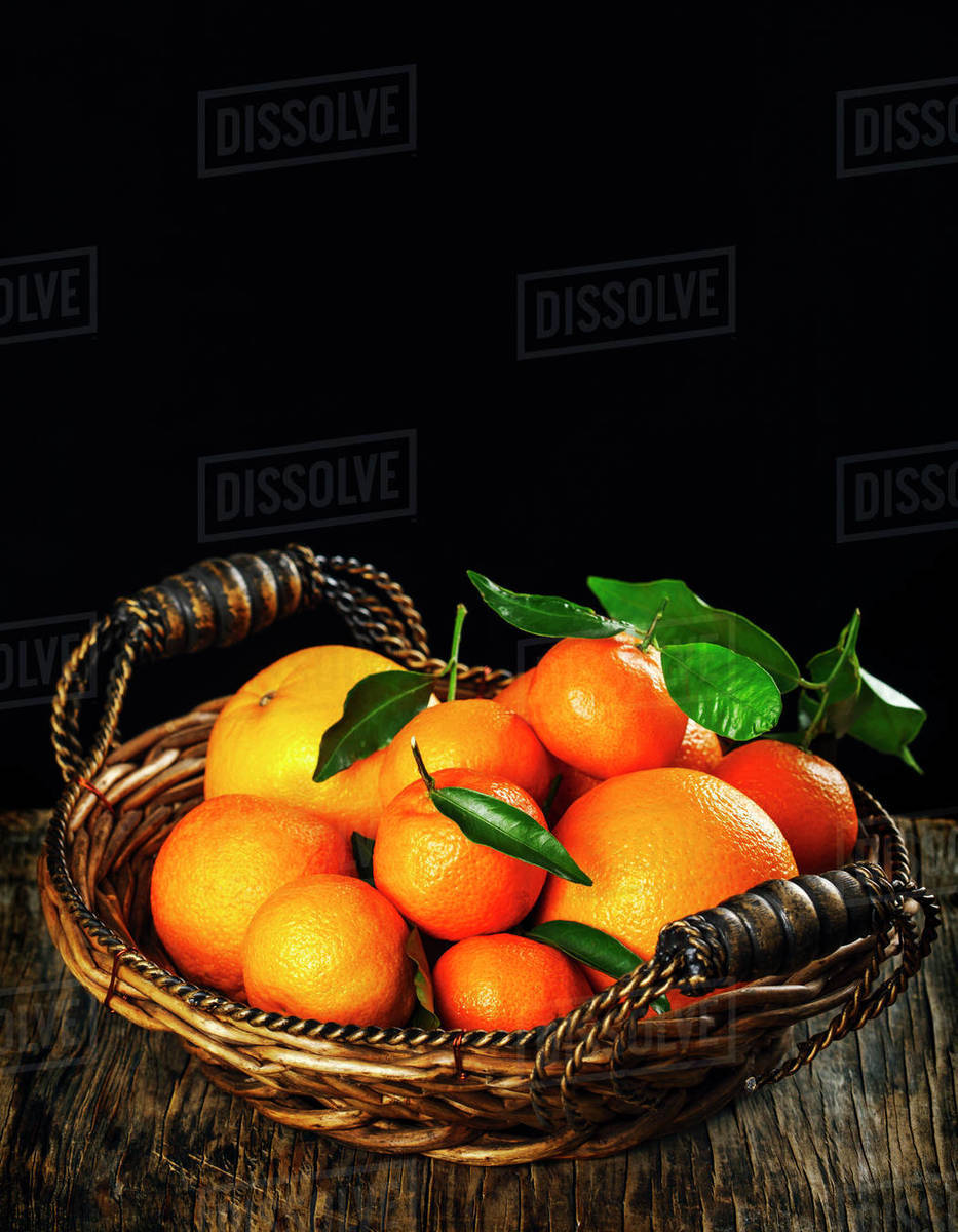 Fresh oranges, satsumas and tangerines in a basket Stock Photo Dissolve