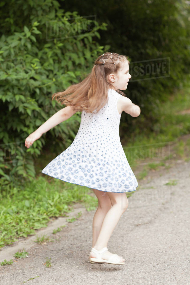 Girl spinning around Stock Photo Dissolve