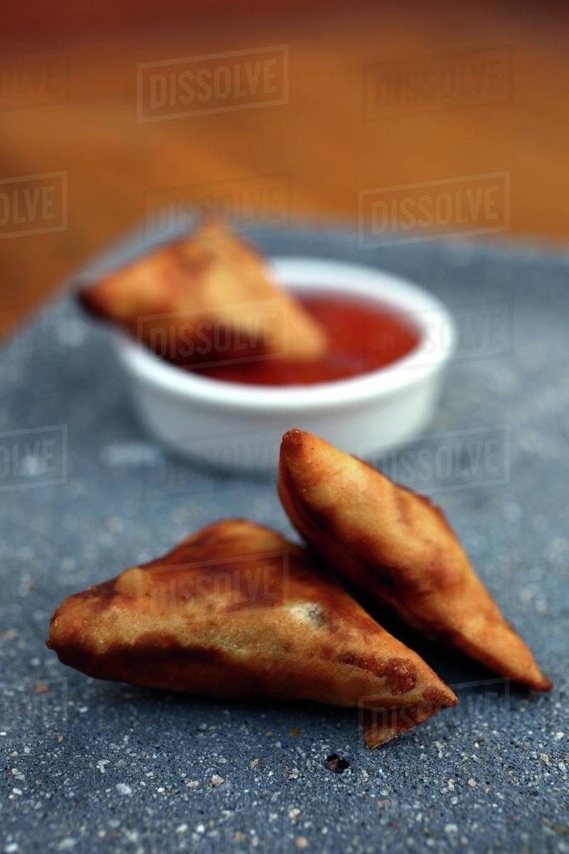 Samosas with spicy dip Stock Photo Dissolve
