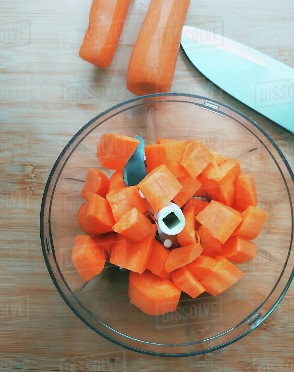 Carrots being chopped in a food processor Stock Photo Dissolve