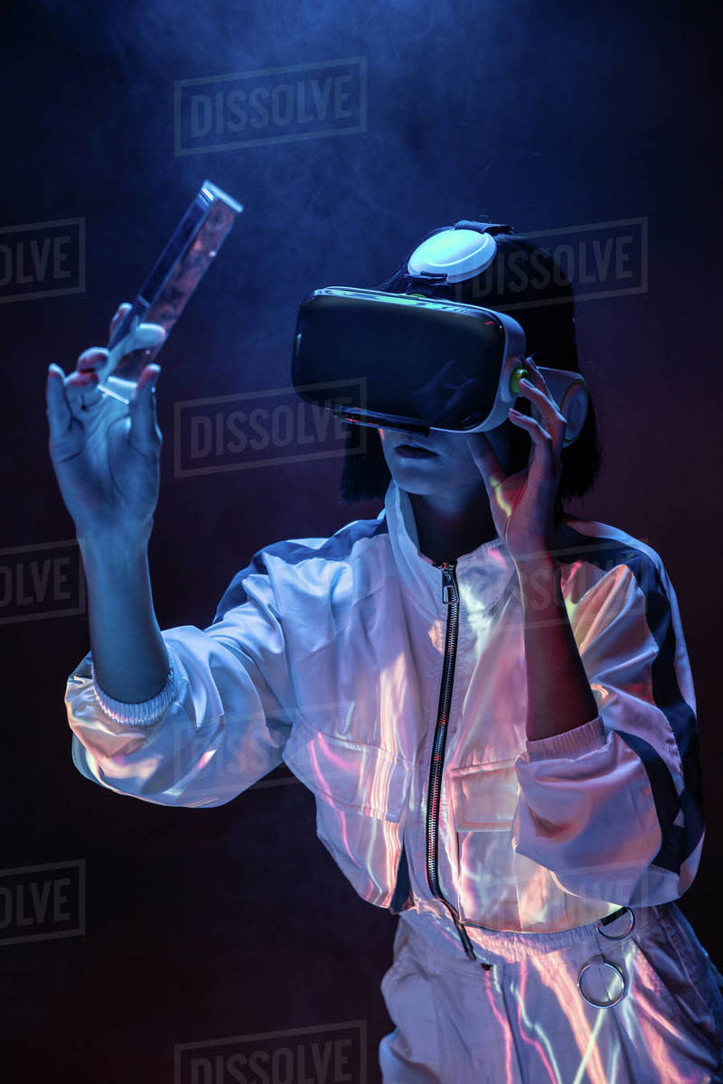 Excited young woman holding a prism while having virtual reality