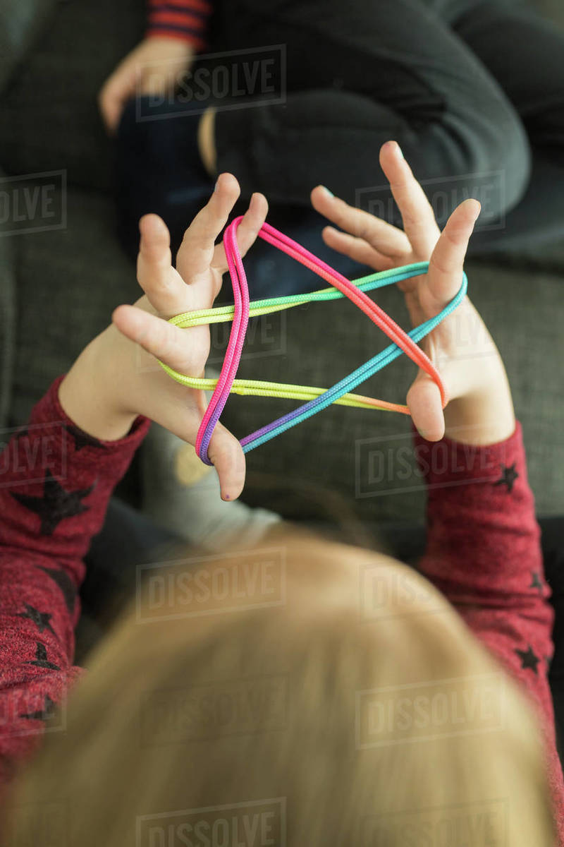 Smart children using rubber bands for game Stock Photo Dissolve