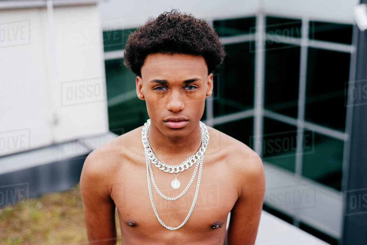 From above serious young African American male with naked torso wearing