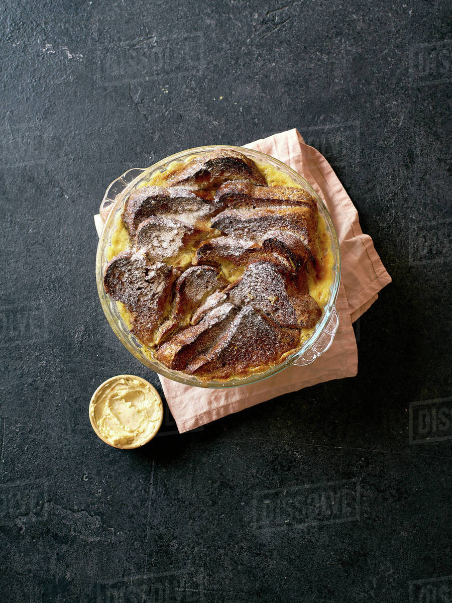 Top view of traditional bread pudding with custard, served with