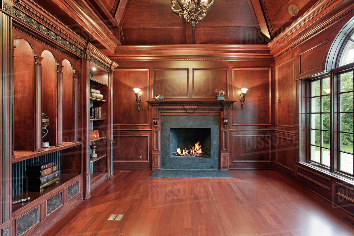 Elegant library in luxury home with black marble fireplace Stock