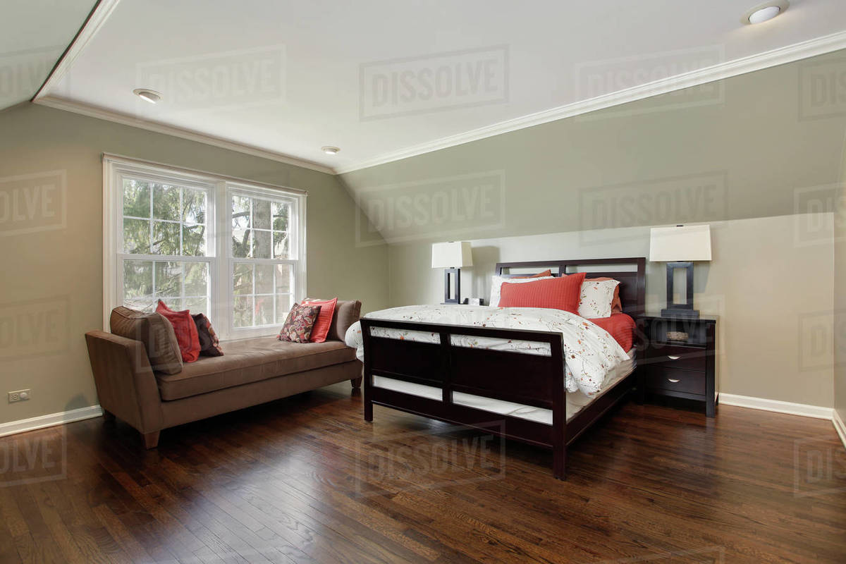 Master bedroom in suburban home with brown sofa Stock Photo Dissolve