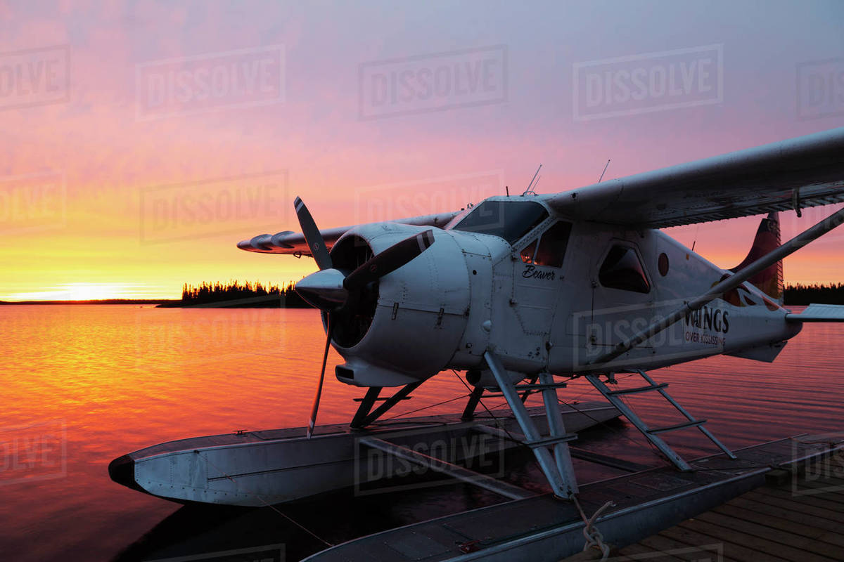 A float plane at the end of a jetty, at sunrise, in Egenolf Lake in northern Manitoba, Canada, North America Royalty-free stock photo