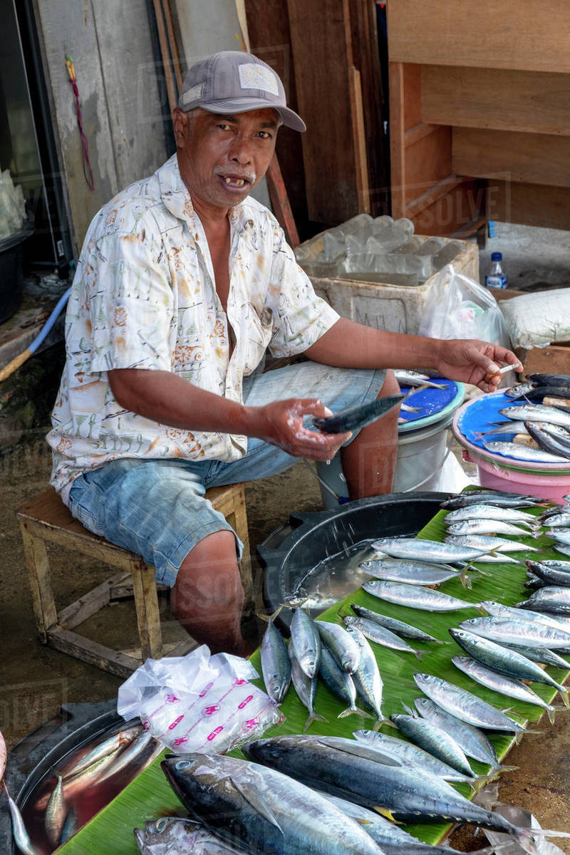 A man selling fish in the local city market, Masohi, Seram, Indonesia, Southeast Asia, Asia Royalty-free stock photo