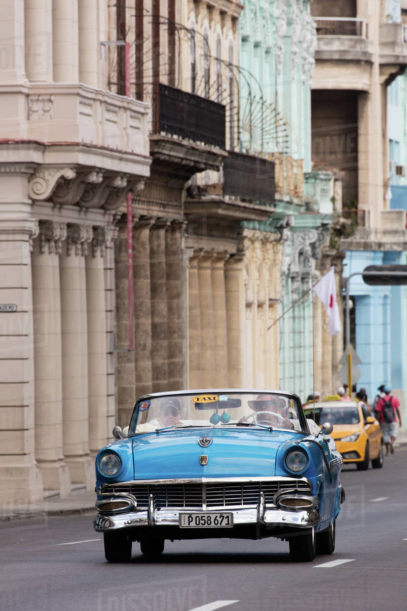 Blue convertible vintage taxi driving along Paseo de Marti in Havana, Cuba, West Indies, Caribbean, Central America Royalty-free stock photo