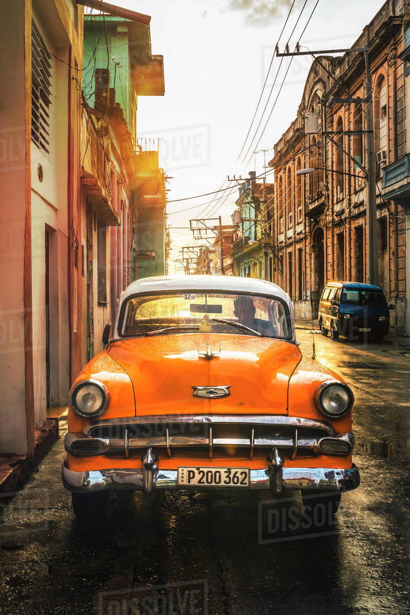 Orange American vintage car at sunset, La Habana (Havana), Cuba, West Indies, Caribbean, Central America Royalty-free stock photo