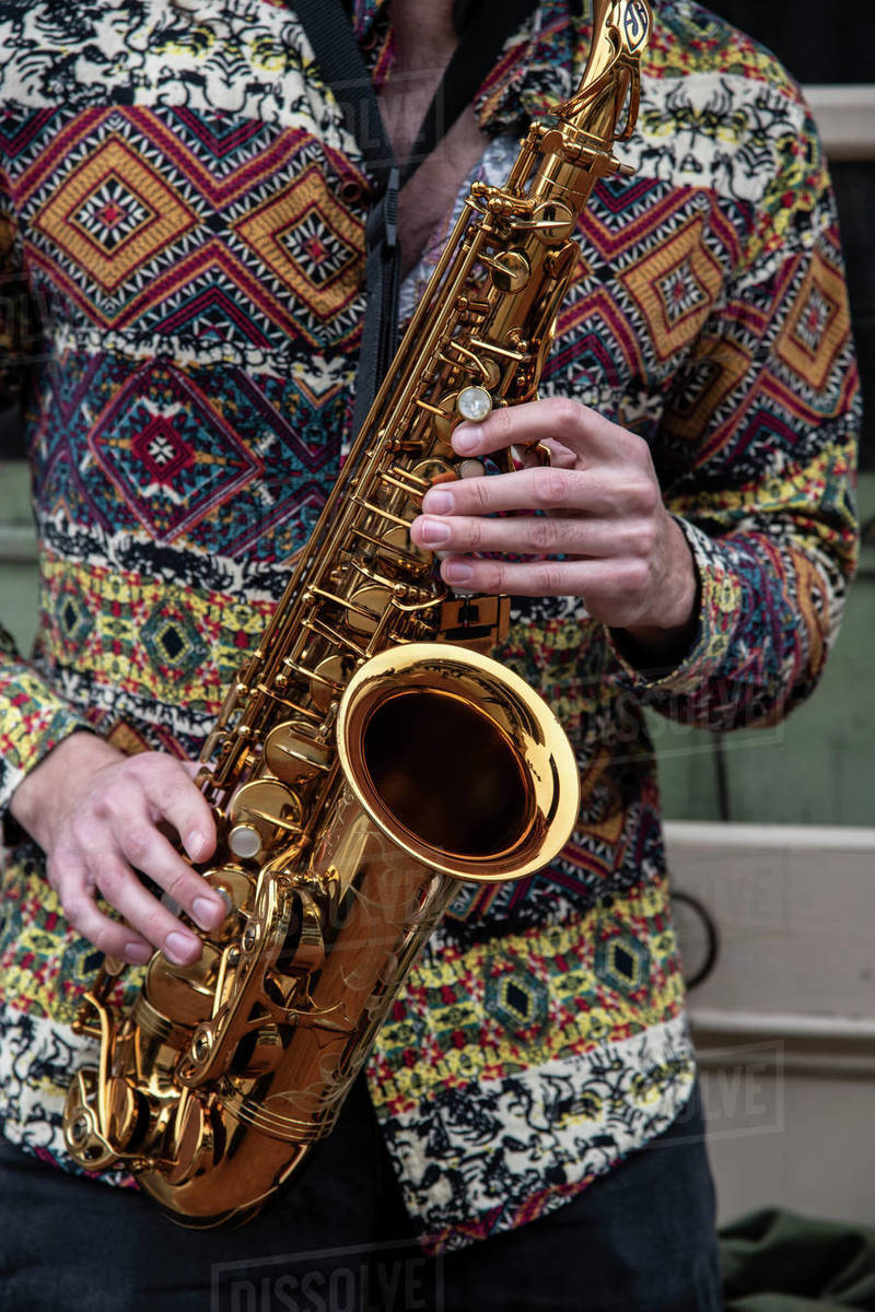 Saxophone player on a Bourbon Street corner in the French Quarter of