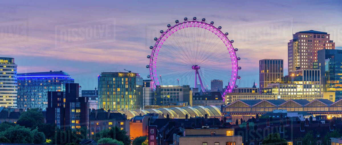 View of the London Eye and rooftop of Waterloo Station at dusk