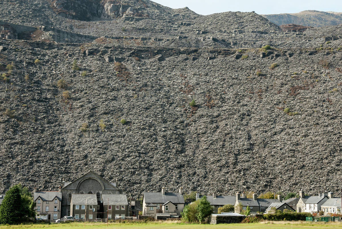 Houses below slate quarry waste heaps, Blaenau Ffestiniog, Gwynedd