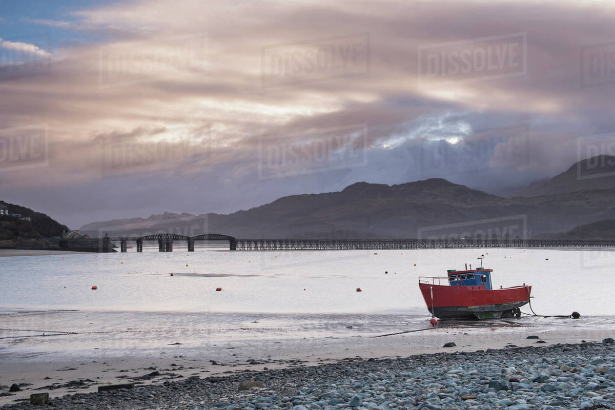 Fishing boat and Barmouth Bridge in Barmouth Harbour with Cader (Cadair