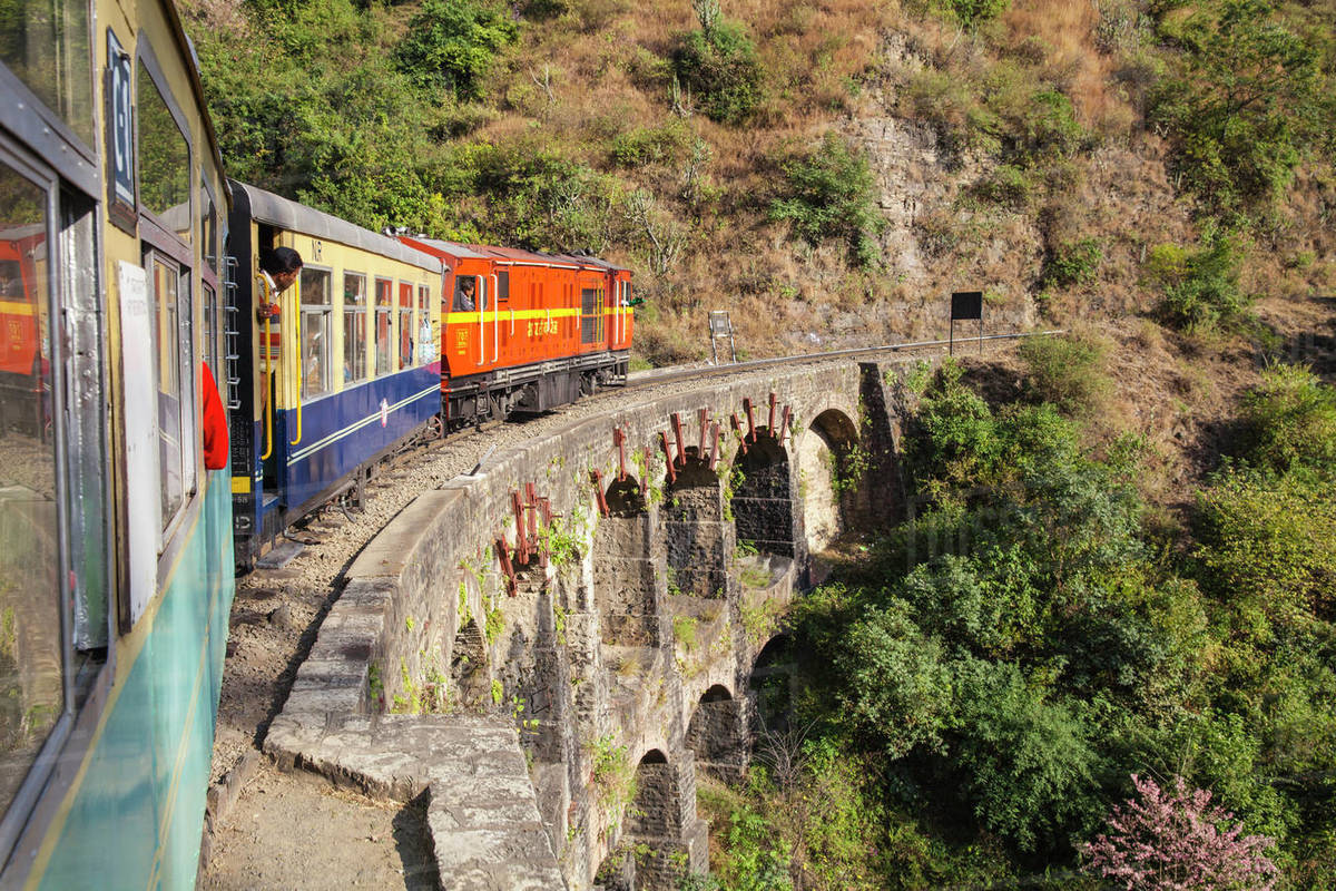 The Himalayan Queen toy train crossing a viaduct, on the Kalka to Shimla Railway, UNESCO World