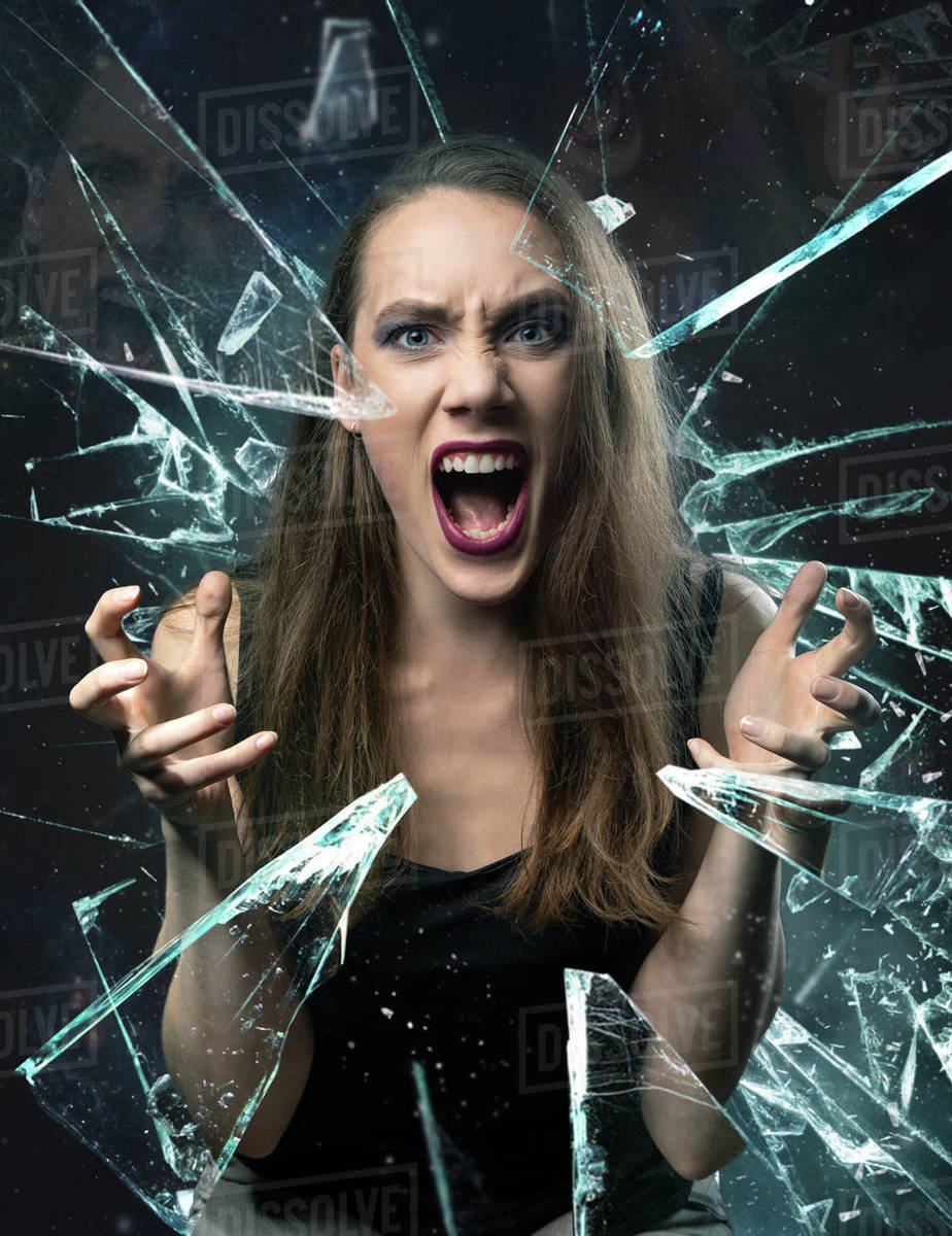 Photo of screaming young woman with broken glass Stock Photo Dissolve