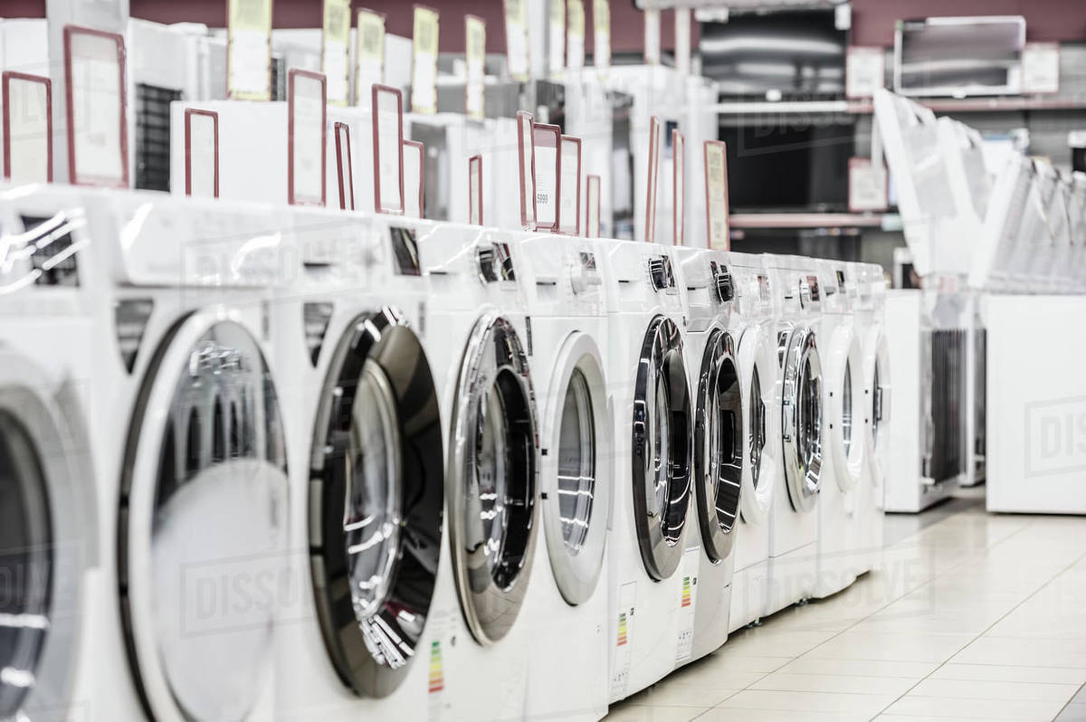 Row of washing machines in appliance store Stock Photo Dissolve