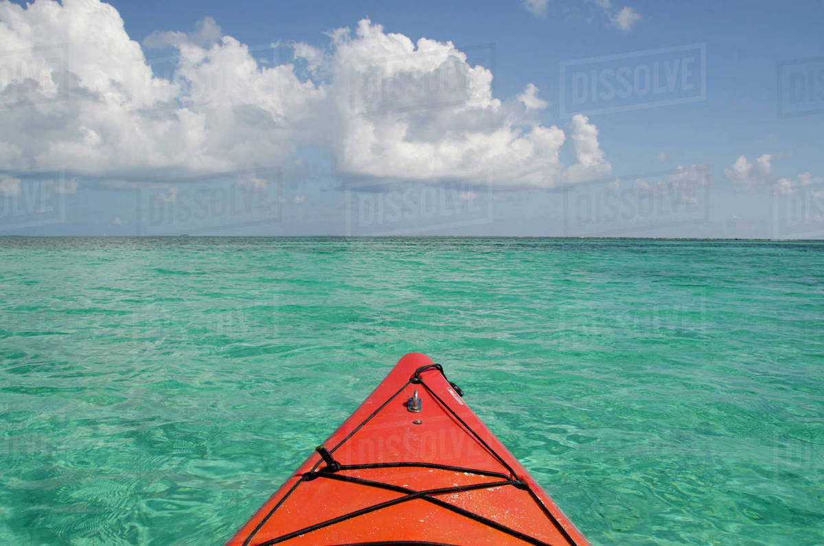 Belize, Caribbean Sea, District of Stann Creek, Southwater Cay. Kayaking in the clear waters off