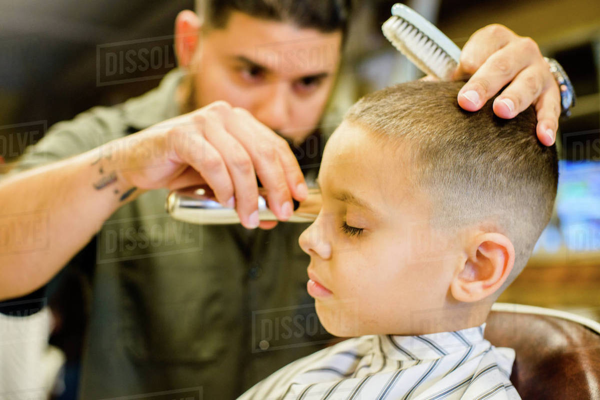 Barber Shaving Boy S Hair Stock Photo Dissolve