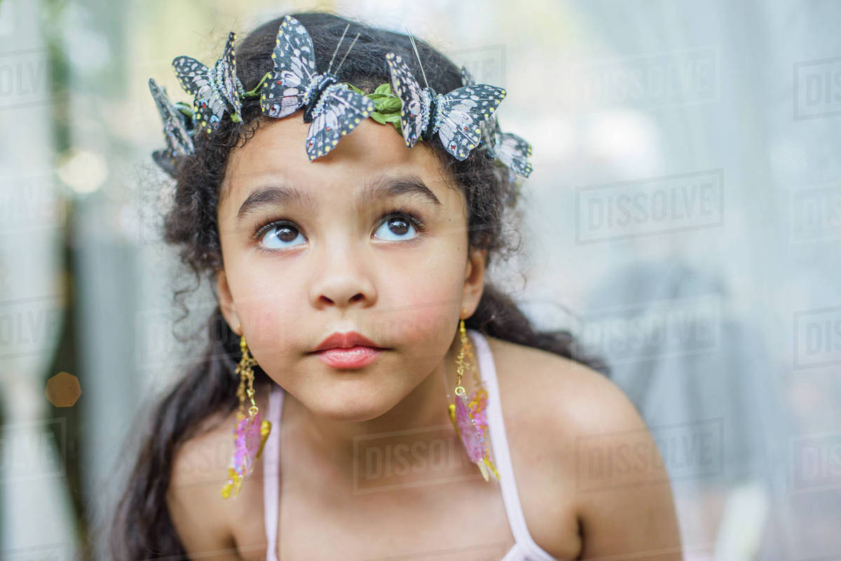 Portrait of young girl, outdoors, wearing butterflies in hair Royalty-free stock photo