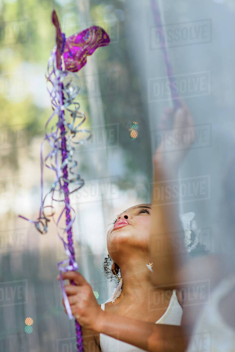 Young girl dressed as fairy, holding wand, playing outdoors Royalty-free stock photo