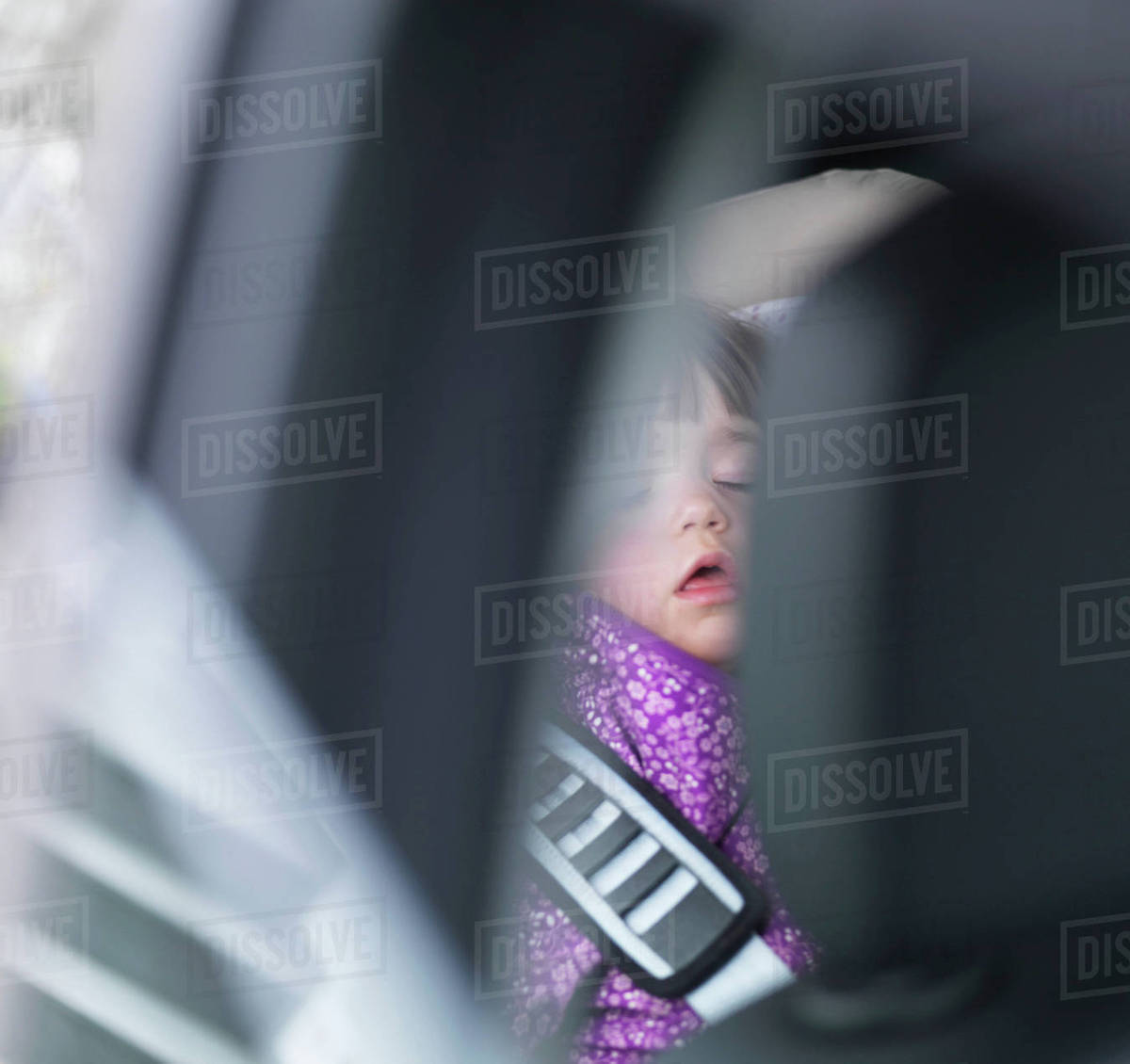 Girl sleeping in back of car Stock Photo Dissolve