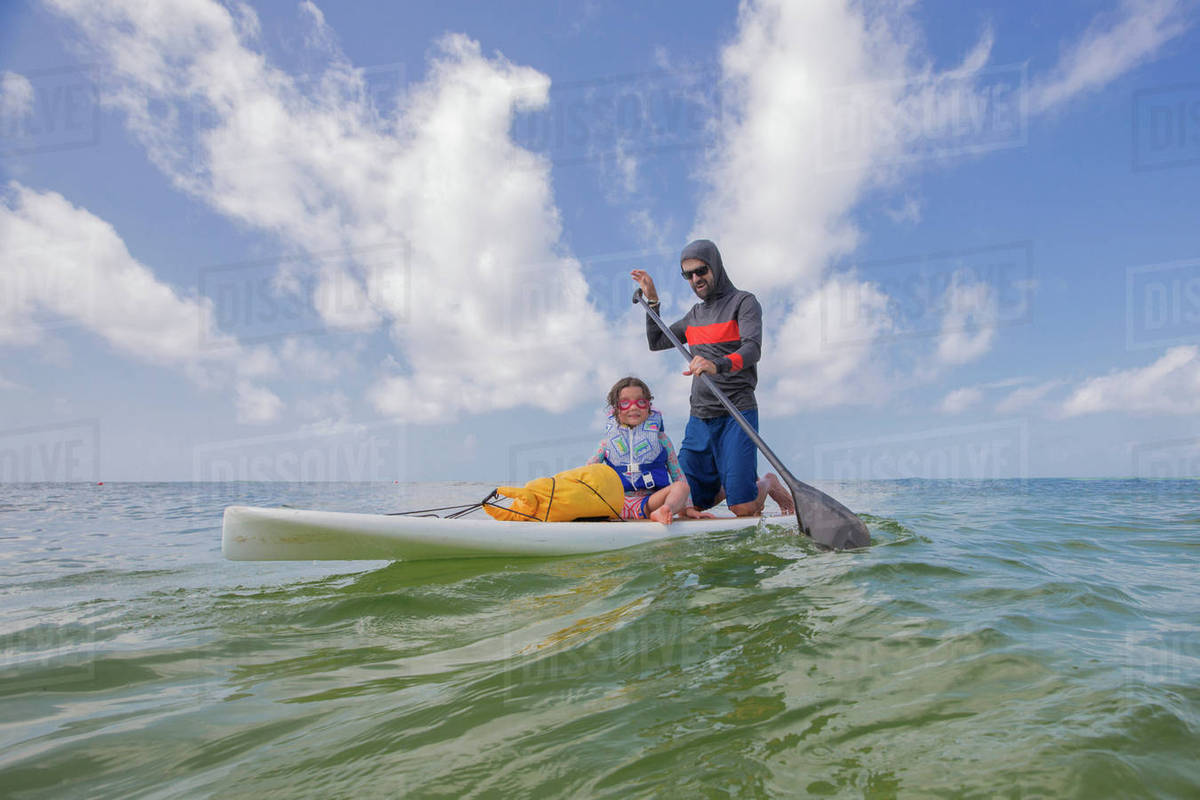 Father and daughter paddle boarding in the Gulf of Mexico, Destin