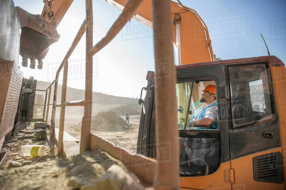 Quarry worker, in quarry, operating heavy machinery Stock Photo