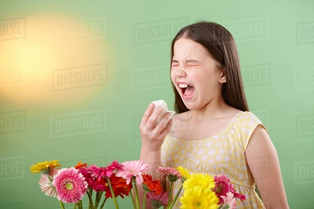 Girl with flowers sneezing Stock Photo Dissolve
