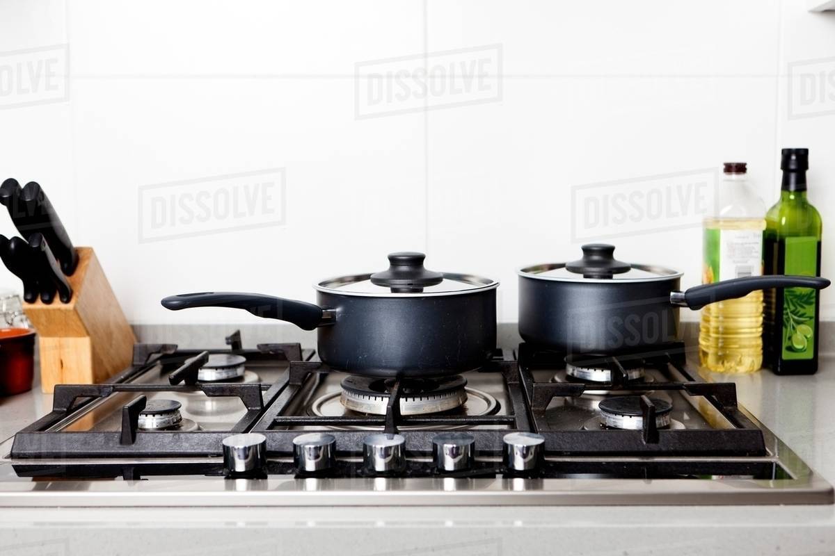 Saucepans on gas hob Stock Photo Dissolve