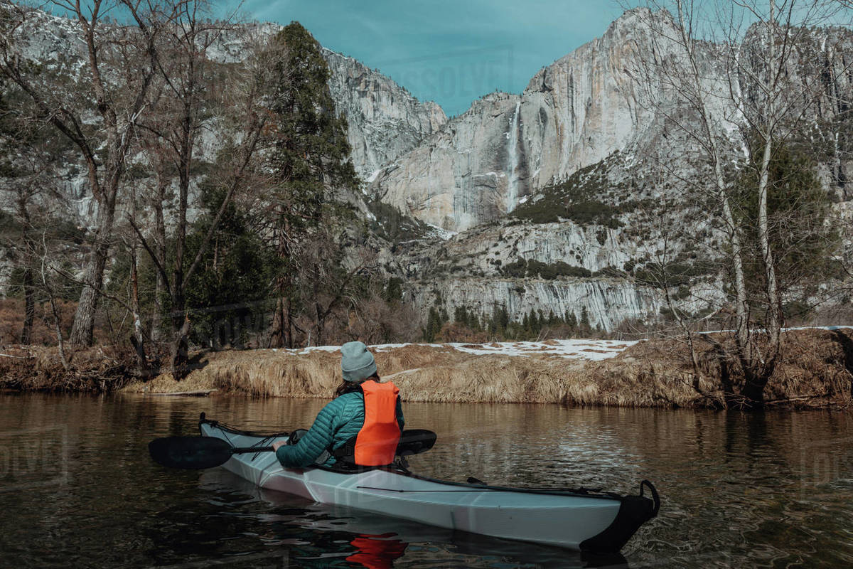 Man kayaking in lake, Yosemite Village, California, United States